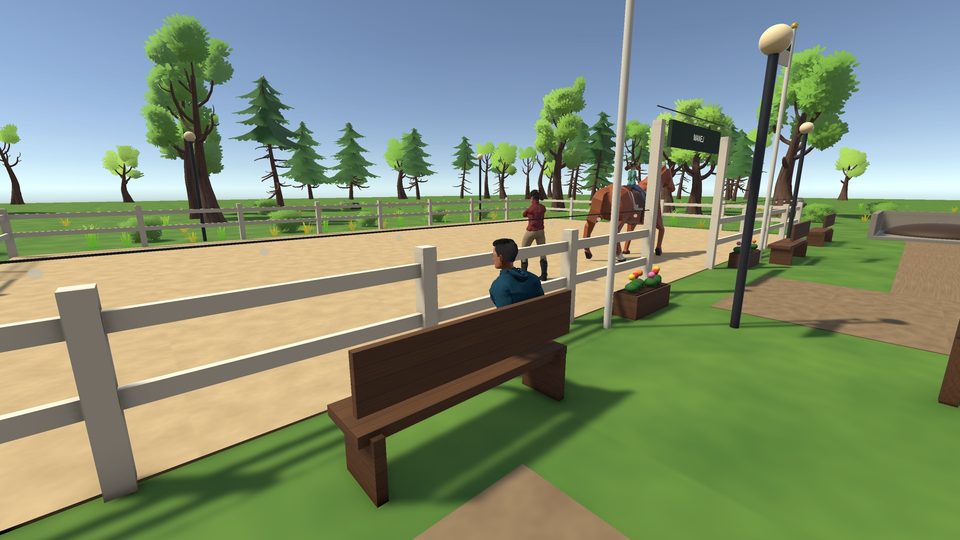 A lesson in the arena while a parent watches from the bench